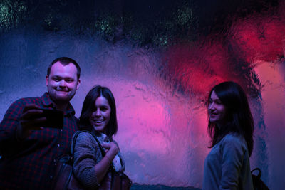 Friends standing at aquarium