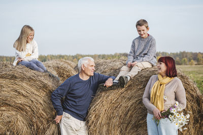 Full length of father and daughter on farm