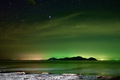 Scenic view of lake against sky at night