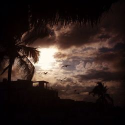 Silhouette of building against cloudy sky