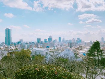 Panoramic view of buildings in city against sky