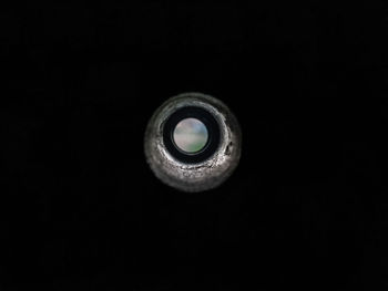 Close-up of light bulb over black background