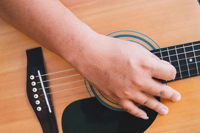 Cropped hand playing guitar