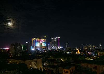 High angle view of illuminated buildings against sky at night