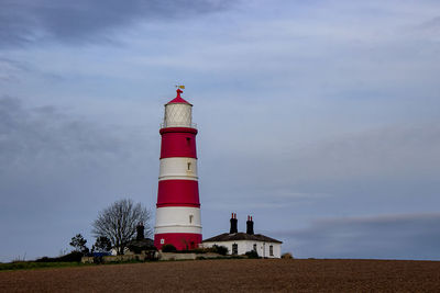 Happisburgh lighthouse on the top of a hill on the coast of norfolk, uk