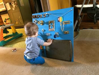 High angle view of boy playing with toys on floor