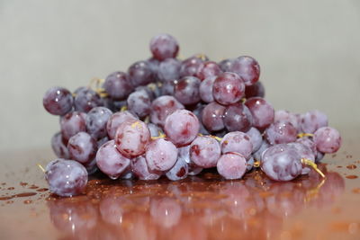 Close-up of wet grapes on table
