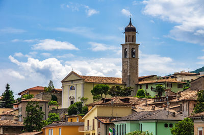 View of bell tower and houses against sky