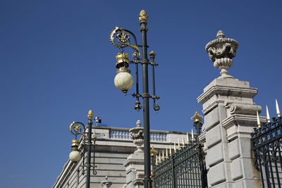 Low angle view of statue of building against blue sky