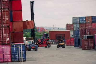 Vehicles on pier against sky