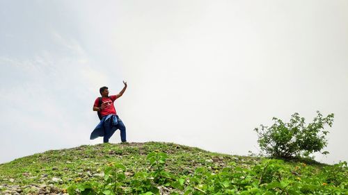 Full length of man standing on land against sky