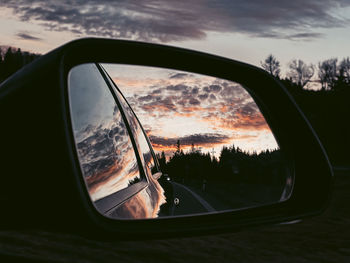 Reflection of sky on side-view mirror