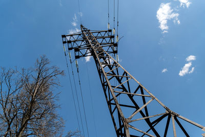 Low angle view of crane against sky