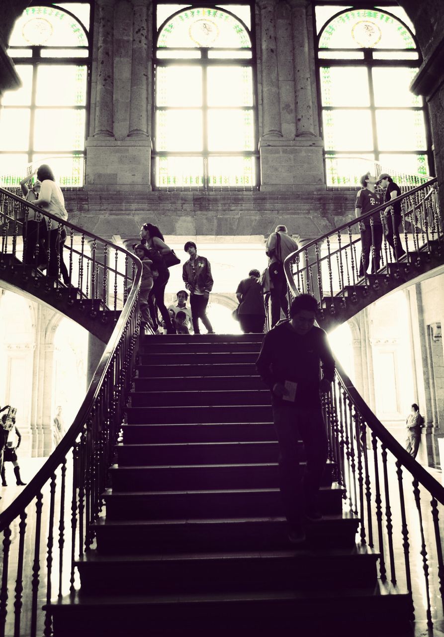 railing, architecture, men, steps, built structure, steps and staircases, lifestyles, staircase, indoors, person, silhouette, leisure activity, walking, full length, low angle view, stairs, large group of people, medium group of people, city life