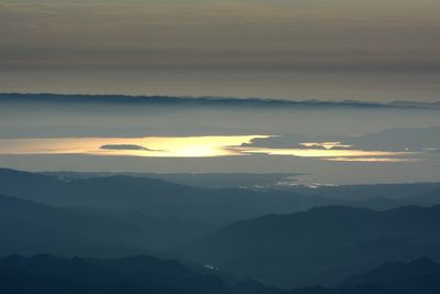 Scenic view of silhouette mountains against sky during sunset