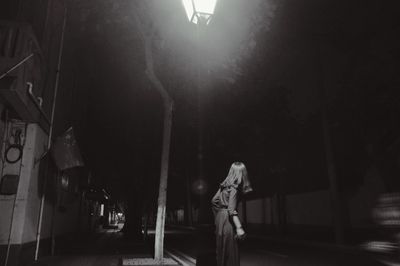Rear view of man standing at night