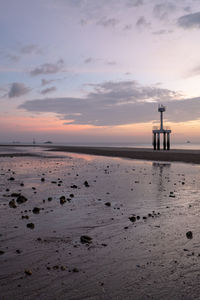 Scenic view of beach against sky during sunset