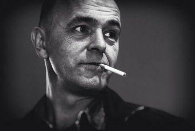 Portrait of man smoking cigarette