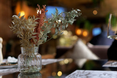 Stylish modern dried flower arrangement in a glass vase with on brown background. boho style