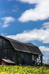 Built structure on field against cloudy sky