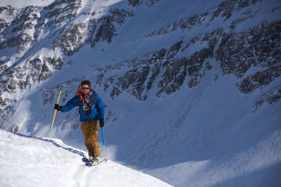 Man in blue jacket ski touring