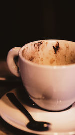 Close-up of coffee cup against black background