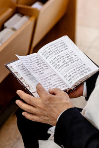 Jewish man praying in the synagogue tample of israel practicing the reading of the torah 
