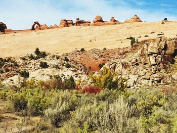 View of rock formations on landscape against sky