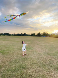 Rear view of girl standing on field