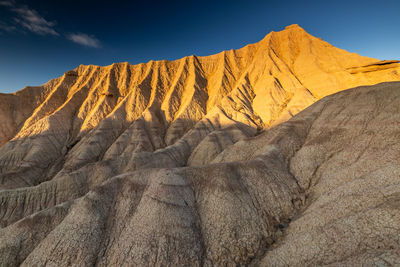 Scenic view of arid landscape against sky. bardenas reales. spain