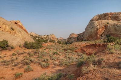 Rock formations on landscape against sky