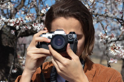 Close-up of woman photographing with camera