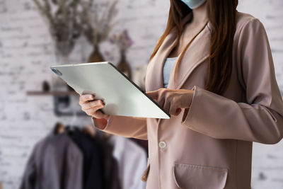 Midsection of woman holding book