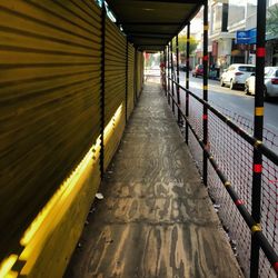 Empty footpath in illuminated underground walkway