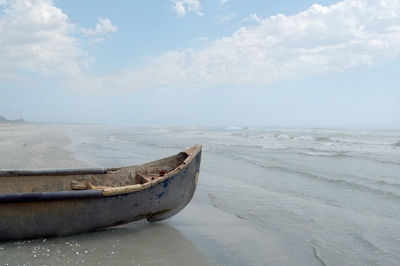 Boat moored on sea against sky