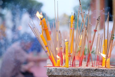 Close-up of lit candles on temple