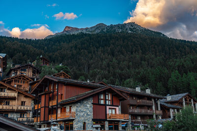 Low angle view of buildings and mountains against sky