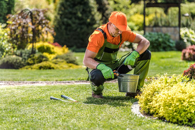 Rear view of man working in park