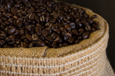 Close-up of roasted coffee beans in sack