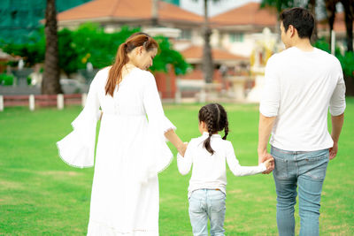 Rear view of mother and daughter outdoors