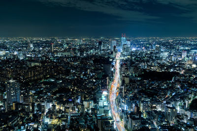 Aerial view of illuminated buildings in city at night