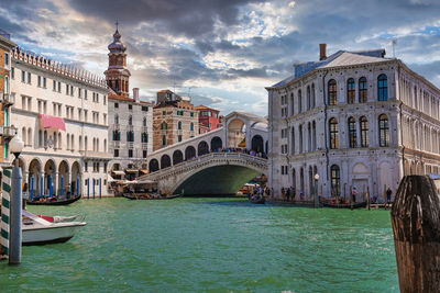 Traditional gondola near world famous canal grande and rialto bridge