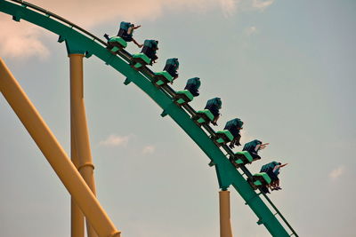 A group of people enjoys a kraken roller coaster ride at seaworld ocean marine theme park