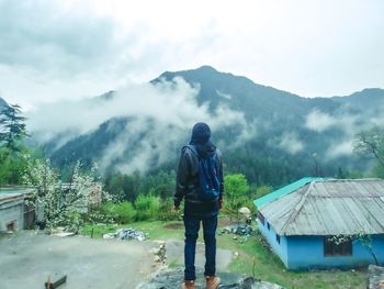 Rear view of man walking on mountain