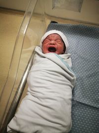 High angle view of baby girl lying on floor