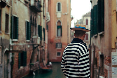 Rear view of gondolier in venice