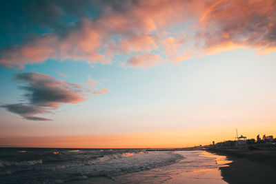 Scenic view of beach against sky during sunset