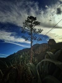 Scenic view of mountains against cloudy sky