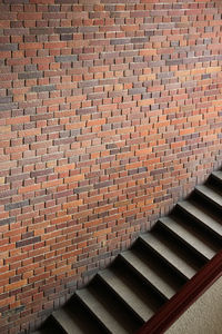 High angle view of steps by brick wall