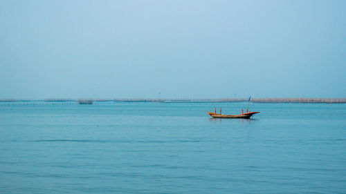 Boat in sea against clear sky